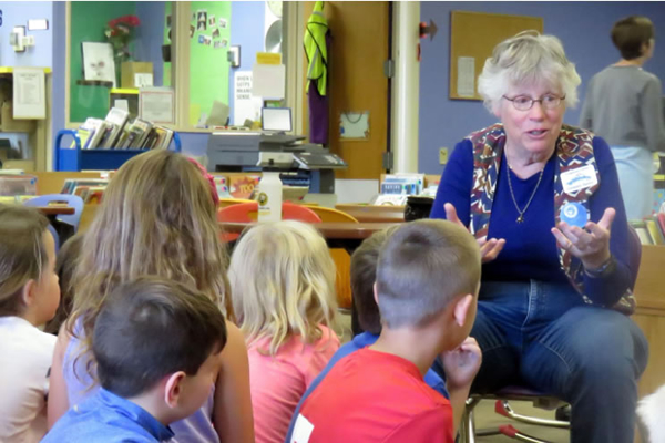 Storytellers interact with students while sharing traditional stories.