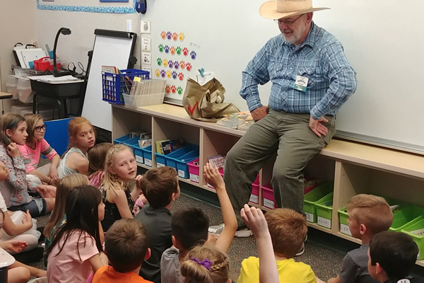 Storyteller interacts with students in the classroom.